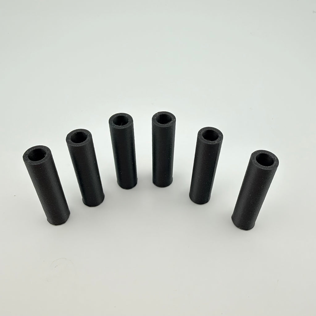 Black carbon fiber reinforced 3D printed round tube spacers standing upright