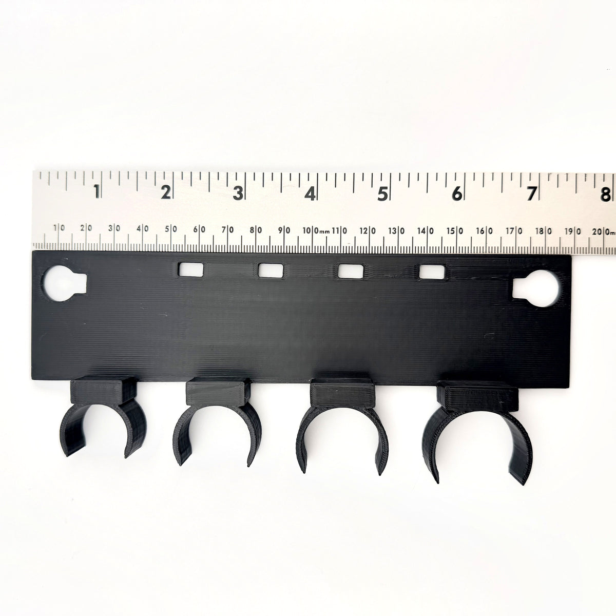 UQD hose parking strip measured against a steel ruler, overall length 189 mm